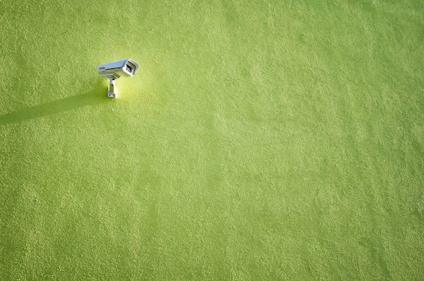 CCTV camera on a green building wall. — Stock Photo, Image