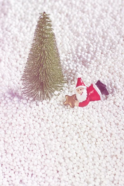 Miniature Santa Claus under the Christmas tree. — Stock Photo, Image