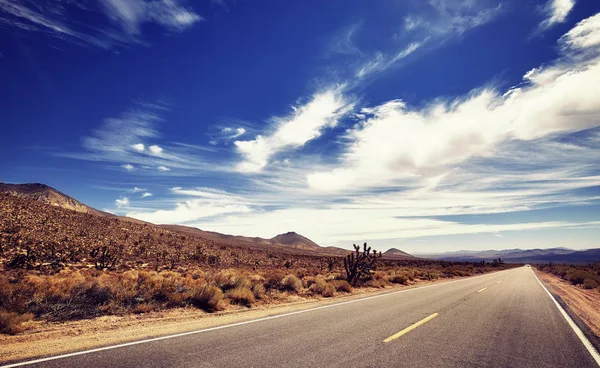 Vintage stylized picture of a Death Valley deserted road, USA. — Stock Photo, Image