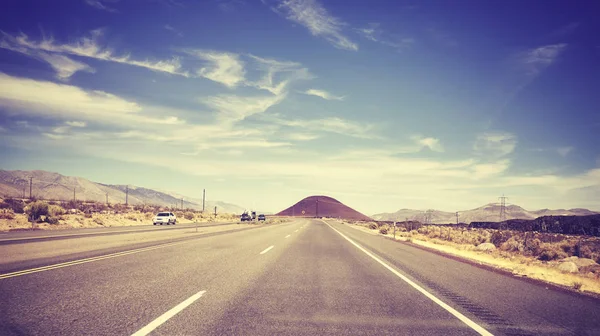 Vintage stylized picture of a highway seen through windshield. — Stock Photo, Image