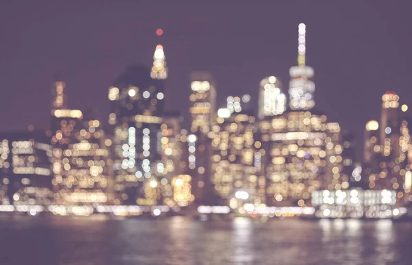 Blurred retro toned picture of Manhattan skyline at night, NYC. — Stock Photo, Image