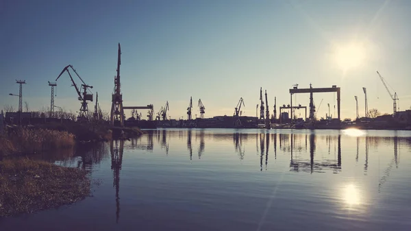 Shipyard Cranes Silhouettes Reflected Water Sunset Color Toning Applied — Stock Photo, Image