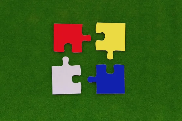 Four Colorful Puzzles Green Background Components Collecting — ストック写真