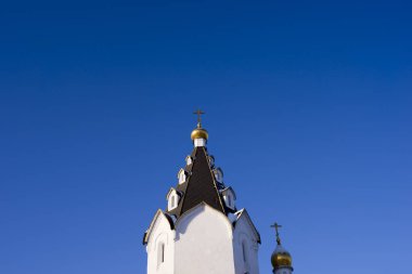 Domes of an Orthodox Church against a blue sky. Religious building, architecture.
