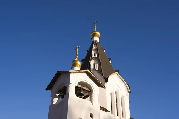 Domes of an Orthodox Church against a blue sky.