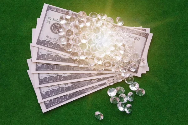 Precious stones, American dollars on a green background. Sale, purchase, precious stones. jewelry business.