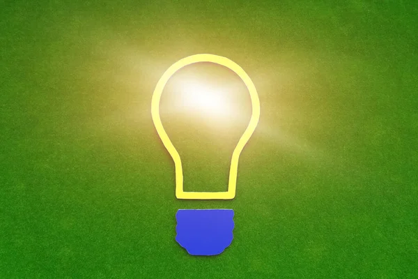 Light bulb on a green background. The concept of creativity, the business idea.