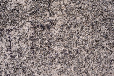 Duvarın dokusu beton ve taş parçalarından yapılmış. Yapı.