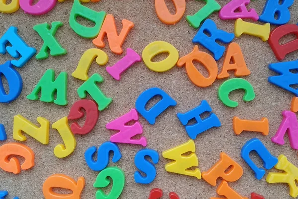 The colored letters of the English alphabet are arranged in a chaotic order.