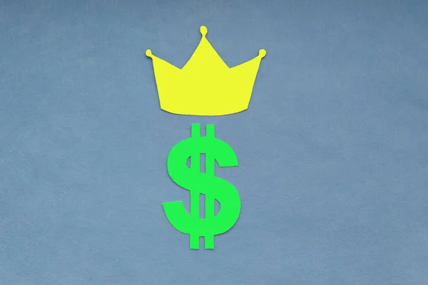Crown, green dollar sign on a blue background. Business, Finance, the increase in the dollar.