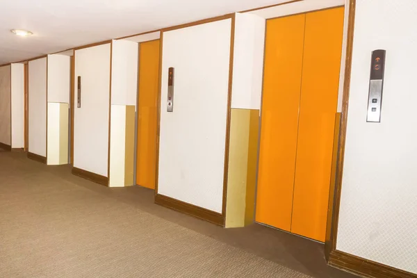 Elevators orange color in hotel lobby — Stock Photo, Image