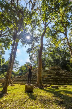woman at Mayan pyramid in The Copan Ruins temples, Honduras