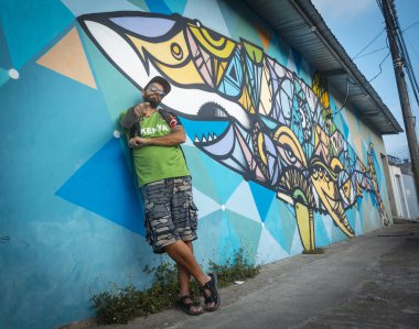 Tela, Honduras - Ocak 2020: Tela kıyısındaki grafiti duvarında genç bir adam