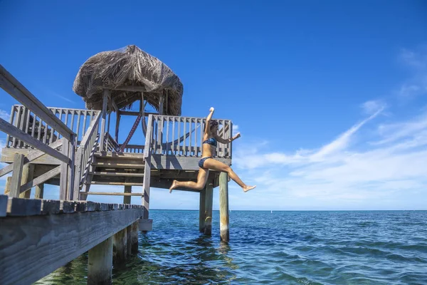 Woman Jumping Sea Water Wooden Pier — 스톡 사진