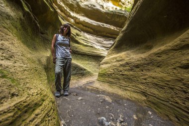 woman walking through the canyons of Naivasha Hells Gate National park. Kenya