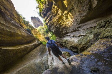 man walking through the canyons of Naivasha Hells Gate National park. Kenya
