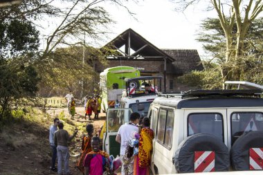 Masai Mara, Kenya - August 2018: A group of Masai women trying to sell something to tourists who are going to enter the Masai Mara national park