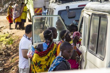 Masai Mara, Kenya - August 2018: A group of Masai women trying to sell something to tourists who are going to enter the Masai Mara national park