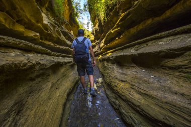man walking through the canyons of Naivasha Hells Gate National park. Kenya