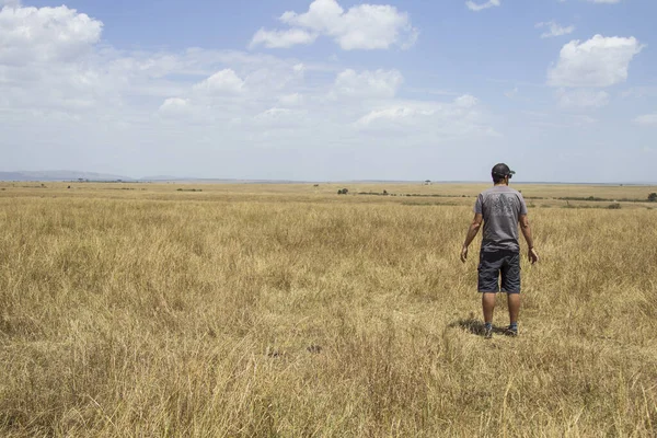 young man in a field, Masai Mara, Kenya