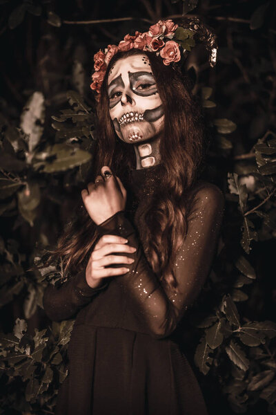 Portrait of young woman with scary Halloween makeup, Day of the Dead theme