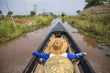 Inle Lake, Myanmar - Spring, 2018: Inside a nice boat with local people in the Inle Lake of Myanmar