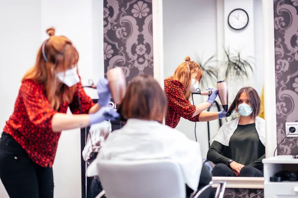 Maskeli Eldivenli Kuaför Müşteri Kurutma Makinesinin Saçlarını Düzleştiriyor Covid Salgınında — Stok fotoğraf