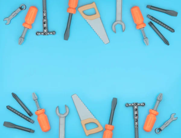 Kids set of working tools on blue background. Father day, construction industry, building and repair concept. Flat lay style with copy space for text.