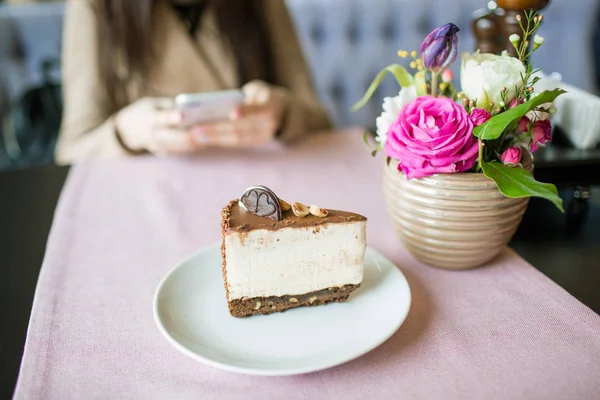 Çikolata kurabiye ve kremalı bisküvi ile krem peynirli kek. Oreo pasta ve masaya çiçek ile güzel bir vazo. Güzel bir buket çiçek gül ve Lale. — Stok fotoğraf