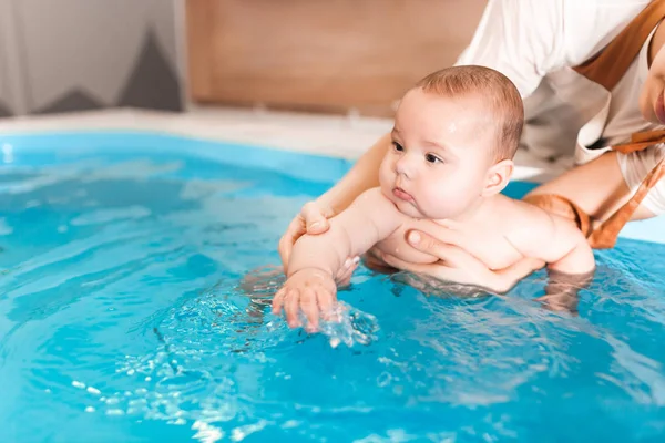 Litle bambino in piscina nuoto durante le procedure sanitarie . — Foto Stock
