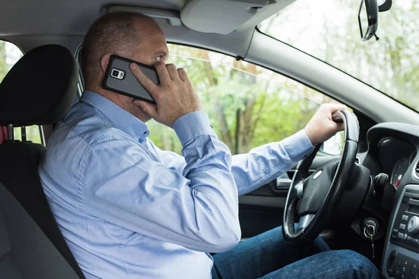 Araba kullanırken telefonu kullanan adam — Stok fotoğraf