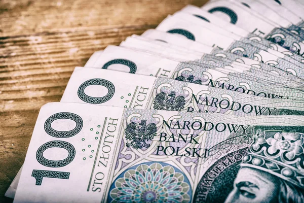 Polish currency PLN, money. File roll of banknotes of 100 PLN (P