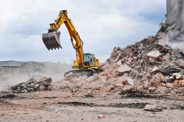 Excavator working at the demolition of an old industrial buildin Stock Photo