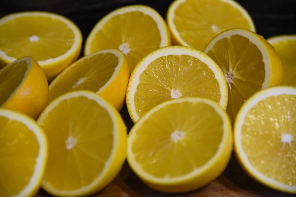 Sliced yellow juicy lemons background