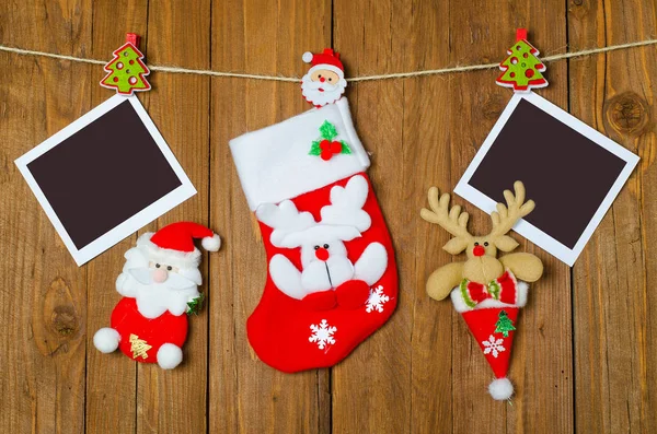 Christmas sock for gifts and an empty picture frame on a wooden — Stock Photo, Image