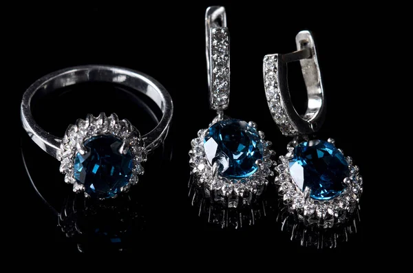 Orecchini e anello in argento fondo nero . — Foto Stock