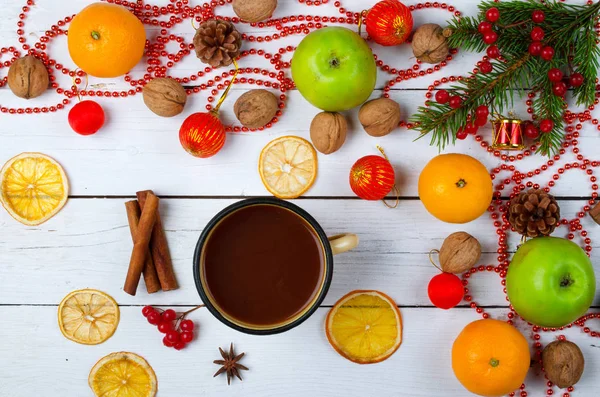 Christmas decoration and a mug of hot cocoa on a wooden table.