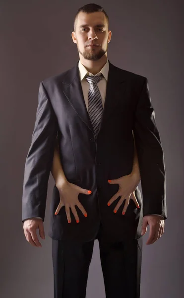 A bearded man in a suit and the woman's hand with red nail polis — Stock Photo, Image