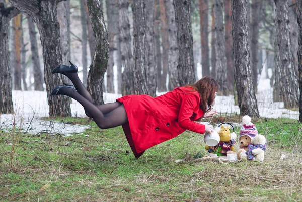 Jeune femme volant dans la forêt avec une bouilloire . — Photo