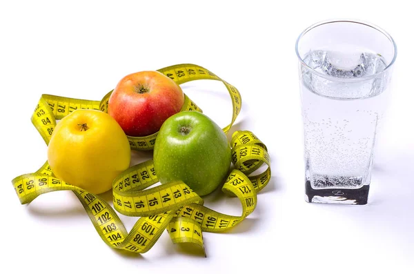 Concept of diet, fresh apples and a glass of water on a light ba — Stock Photo, Image