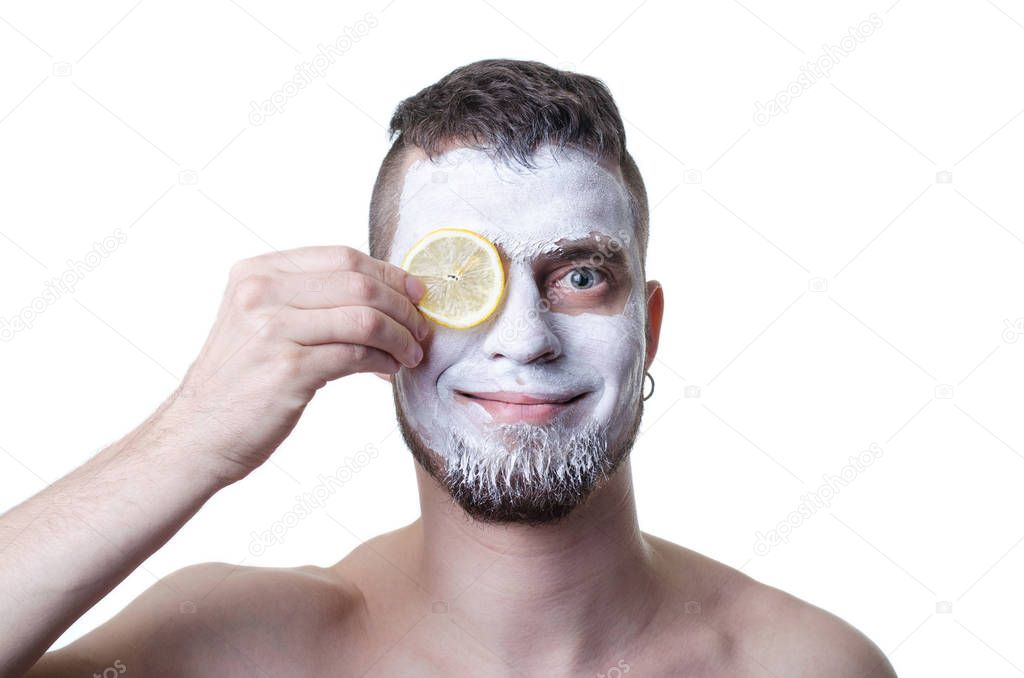 Young man with clay mask on his face, isolated on white.