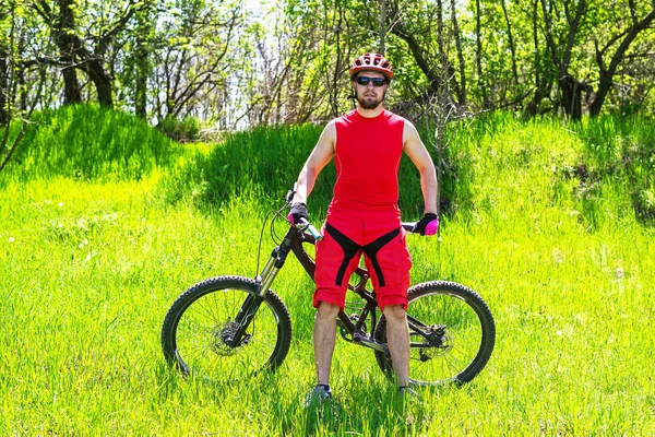 Homme cycliste sur la nature dans l'herbe haute, espace libre . — Photo