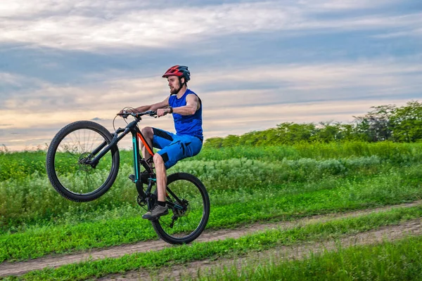 Cyclist Helmet Rides Bicycle Rear Wheel Sunset Wheelie — Stock Photo, Image