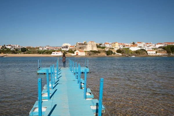 Woman at a beach pier in Vila Nova de Milfontes, in Portugal