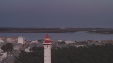 Aerial drone video of Vila Real de Santo Antnio city, lighthouse farol and stadium in Portugal, at sunset