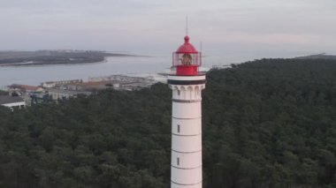 Aerial drone video of Vila Real de Santo Antnio city, lighthouse farol and stadium in Portugal, at sunset