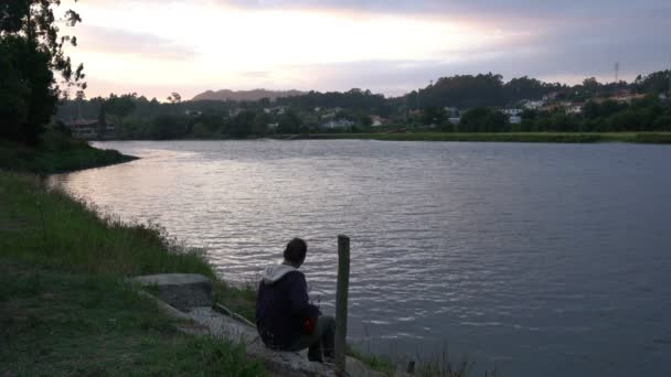 Кавказький Чоловік Співає Грає Гітарою Відпочиваючи Біля Річки Заході Сонця — стокове відео
