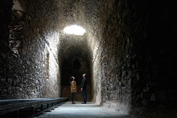 Romantic couple on a dark ruin antique temple arab muslim church tunnel room with a hole where light comes through