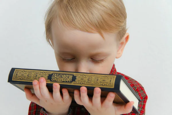 Little muslim European boy with islamic holy book Quran or Kuran — Stock Photo, Image