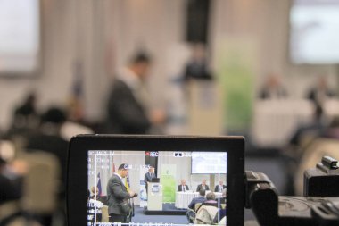 Video konferansı sırasında konferans salonunda ya da salonda oturan iş adamları 
